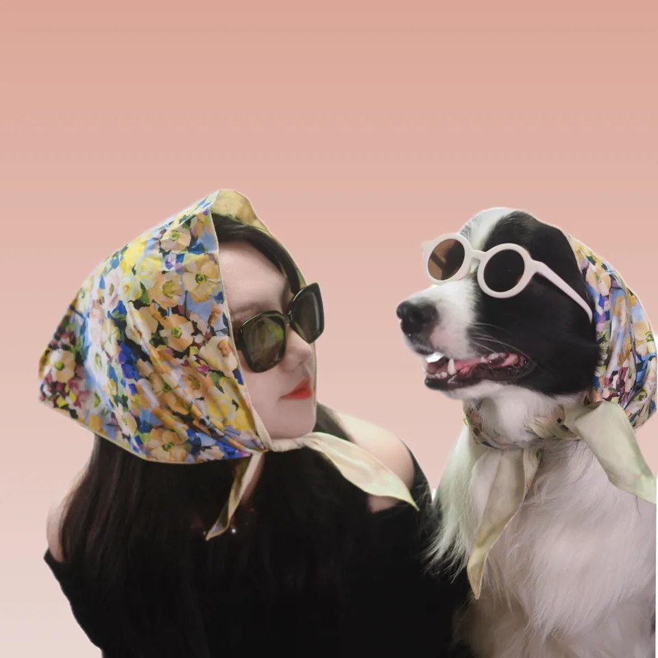 Pepsi and a human in matching floral headscarves and sunglasses
